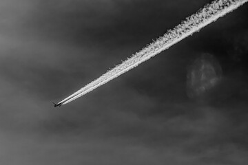 Airliner and its contrail in high contrast bw