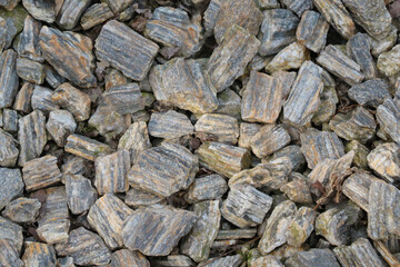 Top view of small pieces of rock on the ground. Background, texture of stone.