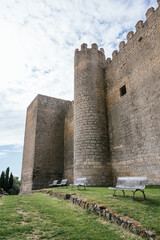 Fototapeta na wymiar Facade of a 13th century medieval castle with several benches