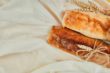 Top view of two baguette bread on a textile surface.