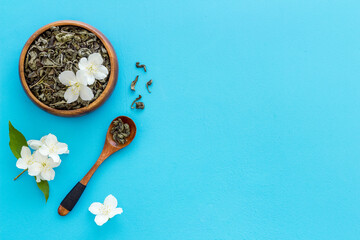Obraz na płótnie Canvas Jasmine hearbal tea in bowl with flowers. Overhead view