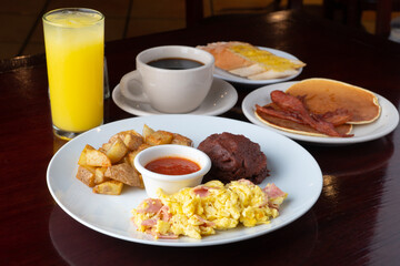 breakfast with beans, potato, tomato sauce and scrambled eggs
