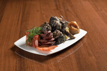 Uzbek Asian cuisine Hasip, meatballs with rice and minced meat in a white plate on the table
