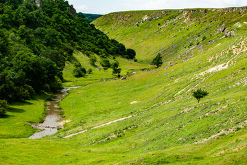 Beautiful green landscapes with hills, forest and rocks in Moldova. Eco tourism without people.