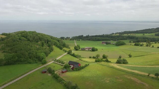 Aerial view of farm on "Bjaredhalvon" with a white car driven on the road