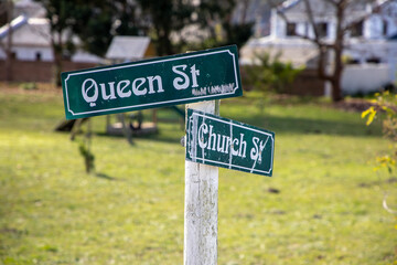 Street name signs with Queen St and Church St written on the signs