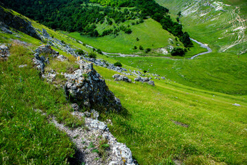 Fototapeta na wymiar Beautiful green landscapes with hills, forest and rocks in Moldova. Eco tourism without people.