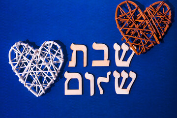 Hebrew letters meaning Shabbat Shalom, in English - Peaceful Saturday. on blue background - obrazy, fototapety, plakaty