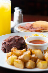 breakfast with beans, potato, tomato sauce and scrambled eggs
