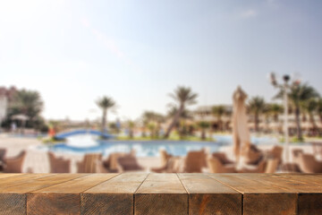 Wooden desk of free space and summer landscape with palms 