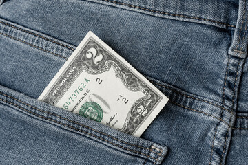 Two dollar bill in jeans pocket. Money in the pocket.