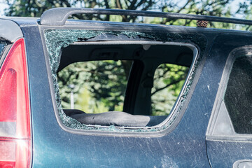 Broken side window in the car. Criminal incident.