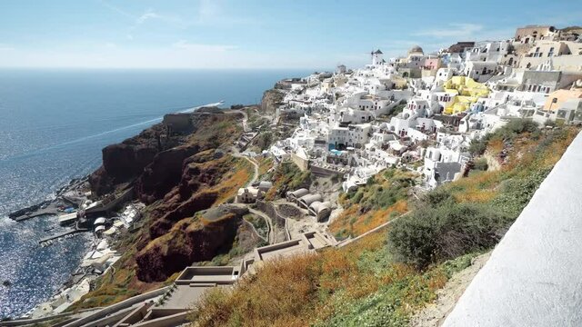 Architecture of Oia village, Santorini island in Greece, on a sunny day with dramatic sky. Scenic travel background.
