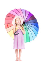 Vertical full length studio portrait of cute Caucasian girl wearing summer dress and hat holding colorful umbrella posing on camera, white background