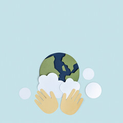 Hands washing the planet earth paper craft background
