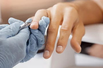 Foto op Aluminium Young man gets professional manicure for hands in spa salon © Parilov