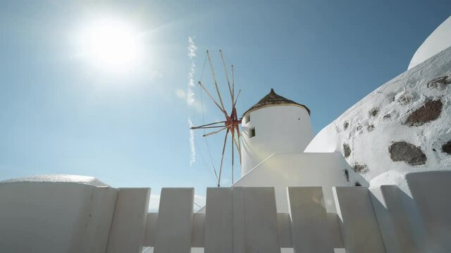 View of windmill in Oia the most beautiful village of Santorini island in Greece.
