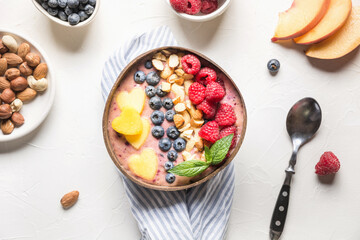 Banana and blueberry smoothie for healthy breakfast in coconut bowl isolated on white background. Without sugar. Top view.