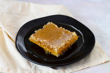 Organic honeycomb on wooden background. honey on the plate