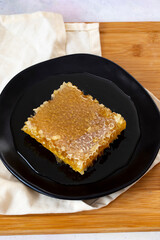 Organic honeycomb on wooden background. honey on the plate