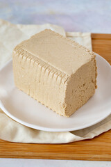 Halva with tahini on wooden background. Local name tahinli helva