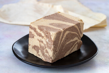 Halva with tahini and cocoa on wooden background. Local name kakaolu ve tahinli helva