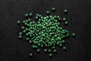 Spirulina pills background. Green tablets superfood.