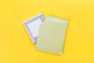 coffee filter or drip coffee in a package on a yellow background, top view