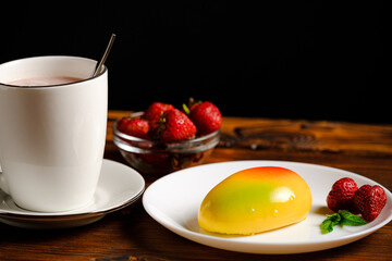 Mango cake on a white plate. Delicious breakfast. Breakfast with strawberries