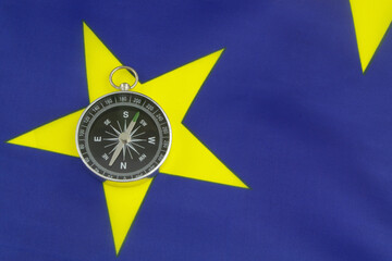 Travel, navigation and ways for developing for European Union concept. Compass on EU flag.