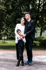 Family portrait with first grader in daylight in the park