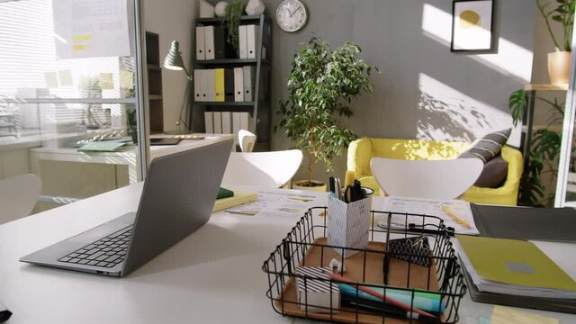 Close Up Shot Of Desk With Laptop, Pens, Documents And Copybooks In Trendy Office With No People