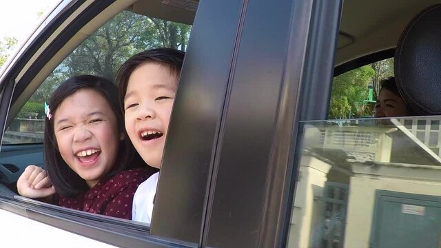 Happy Asian Children Sitting In The Car