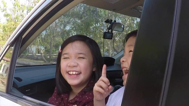 Happy Asian Children Sitting In The Car