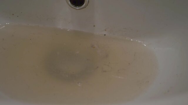 Dirty water in a bathroom sink