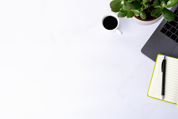 Flat lay, top view office table desk with open blank notebook, computer and coffee cup. Copy space.