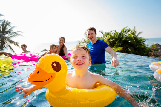 Family playing in a pool