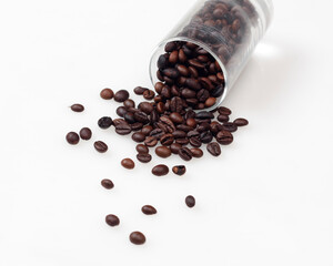Coffee beans on a bright white background. This is an arabica coffee bean. The distinctive taste of Arabica coffee is in the form of a light consistency and a higher acidity level than other coffees.
