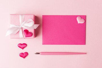 Blank card, gift box and Valentine’s hearts over pink background. Valentines greeting concept