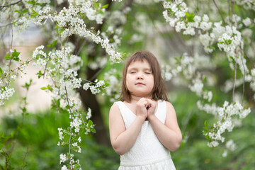 Adorable European kid girl with cherry blossom flowers, spring and self-care, tender child girl photo, childhood