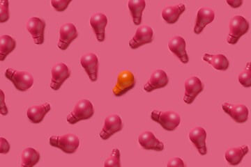 Pattern of light bulbs colored in pink and with single one orange painted lighting bulb isolated on vibrant pink background. Differentiation, creative ideas and unique concept. Flat lay.