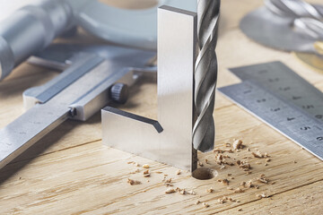 drill bit with steel triangle ruler make sink in hole for screw in wooden oak plank