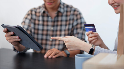 Shopping online concept a lovely couple adding credit card information to use in online financial transaction