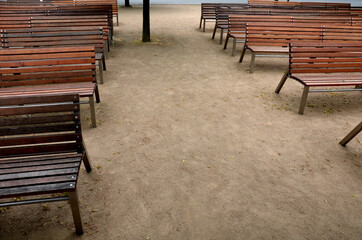 outdoor theater auditorium. Benches stacked in rows. adjacent. There is an alley between the wooden...
