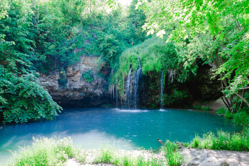 small beautiful waterfall with blue lake