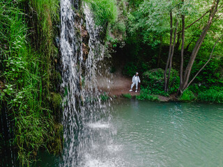 woman hiker enjoying view of waterfall