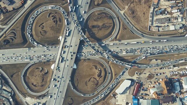 Aerial crossing of different roads, bird's-eye view of the roundabout Highway panorama in the evening at sunset. Leading innovation concept, finance abstraction, transport logistics and infrastructure