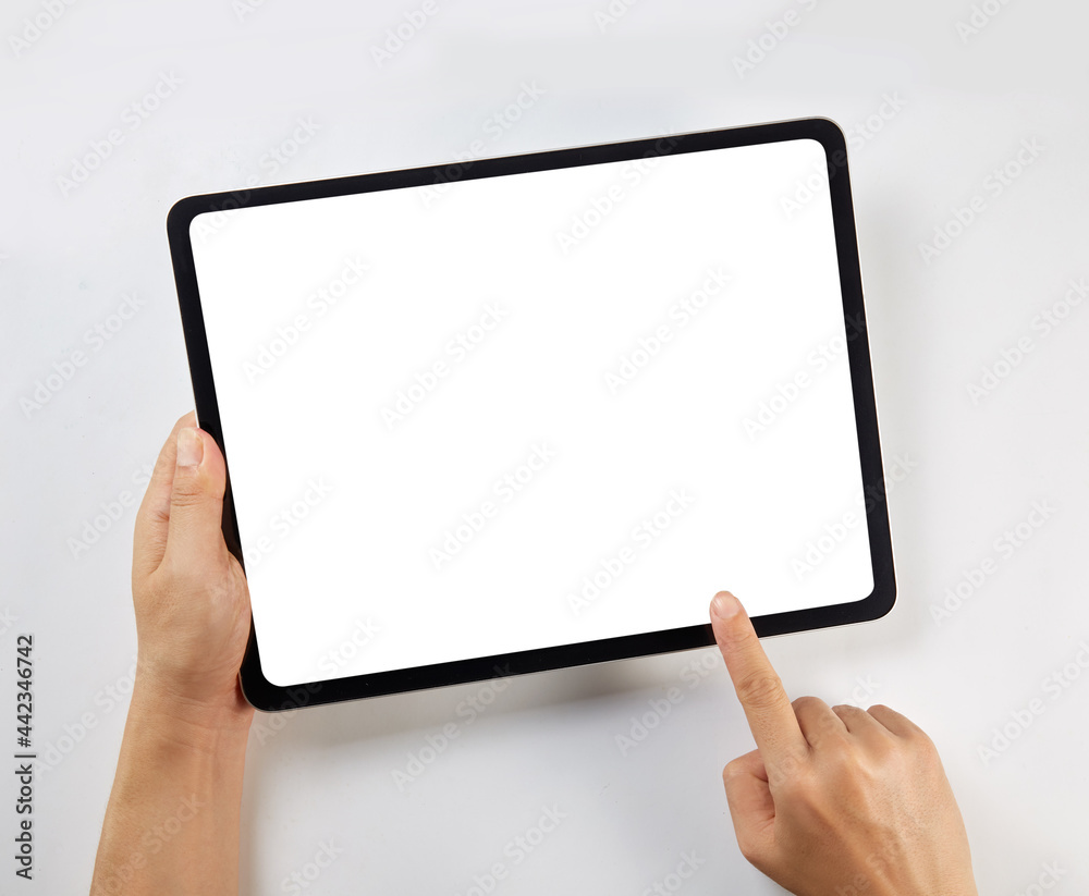 Wall mural hand holding a mockup tablet with blank screen isolated on white