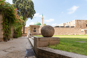 A large  stone core is in the courtyard of the museum in the fortress of the old city of Acre in northern Israel