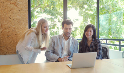 Group of multi ethnic business people meeting, women communicate, discuss and work with computer...